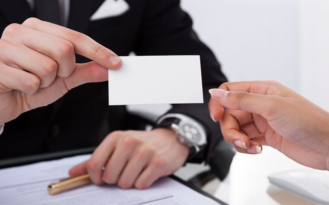 Businessman Giving Business Card To Colleague