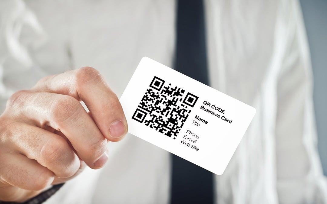 Businessman holding QR code business card