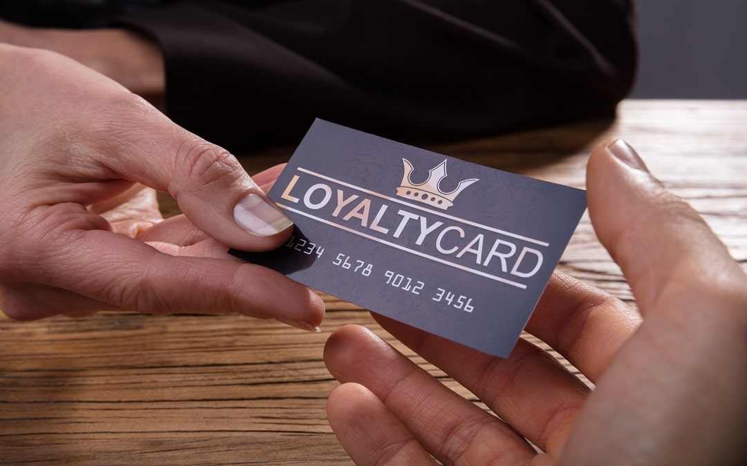 Human Hand Giving Loyalty Card To Another Person