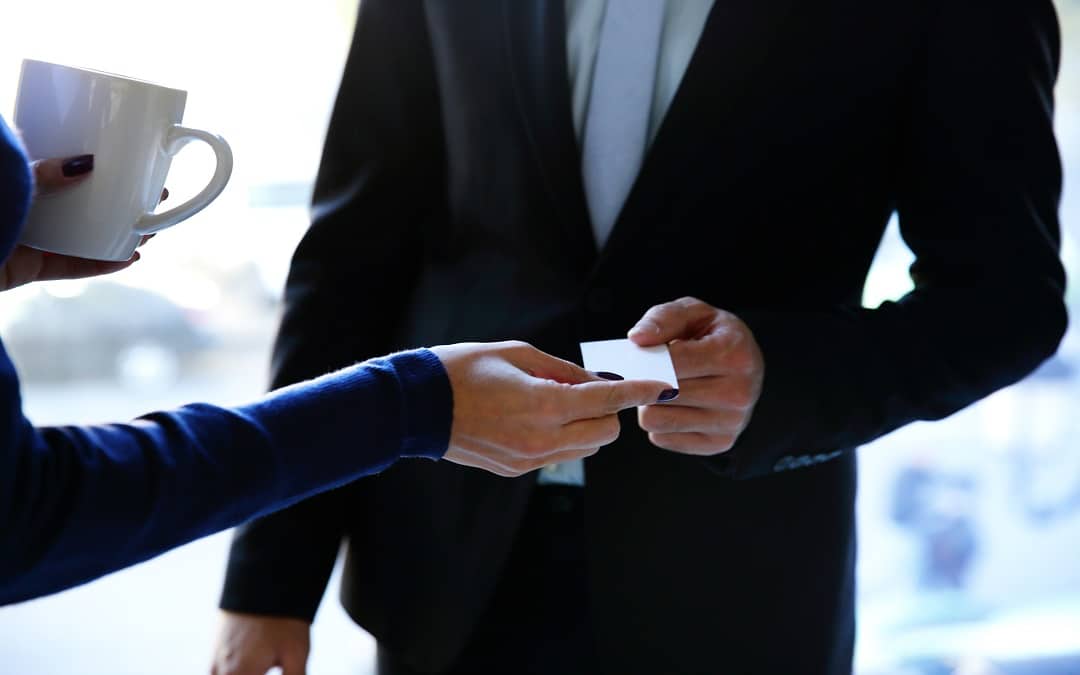 Exchange business card between man and woman